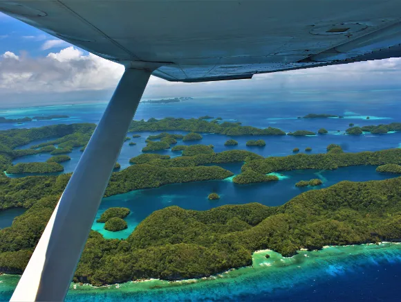 aerial photo of the 70 islands in Palau with airplane's wing in foreground