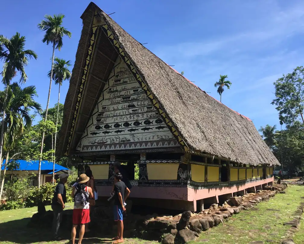 Tourist entering a Bai, a traditional Palauan Men's House