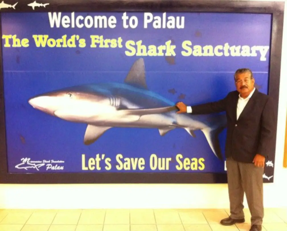 Palauan president at the time, Johnson Toribiong, presenting the Palau Shark Sanctuary sign at the airport