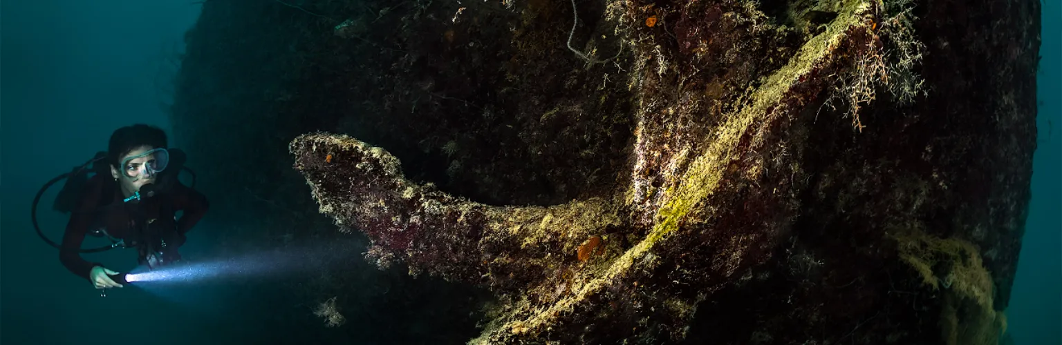 underwater photo of a diver at the huge anchor of a WW2 wreck in Palau