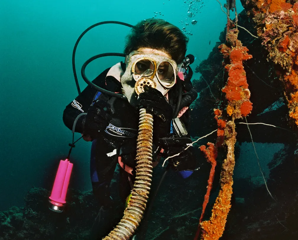 underwater photo of a diver with a gas mask from world war 2 from a wreck in Palau