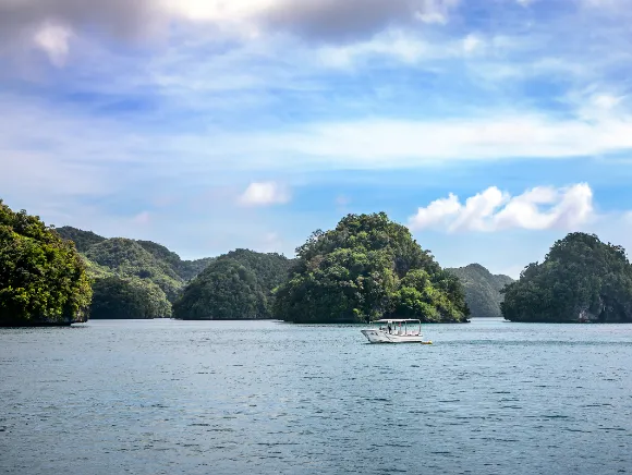 Fish 'n Fins boat in front of the world famous Rock Islands of Palau